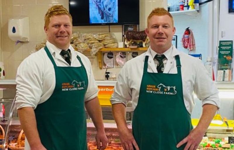 Ginger Butchers in front of their butchers counter in their shop in Bakewell